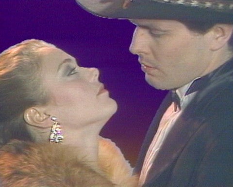 Film still of man and woman embracing